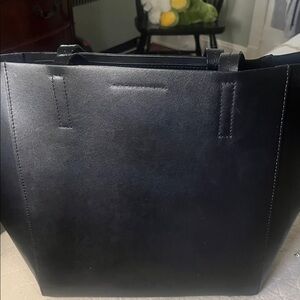 Sleek Black Tote Bag.  Leather.  Excellent condition.  Inside zippered pocket